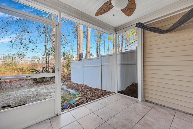 unfurnished sunroom with a ceiling fan