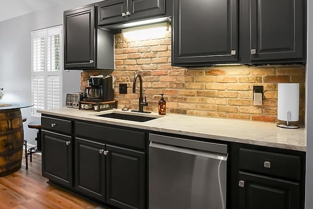 7886 Racquet Rd, North Charleston, SC 29418 - kitchen featuring stainless steel dishwasher, a sink, decorative backsplash, and dark cabinets