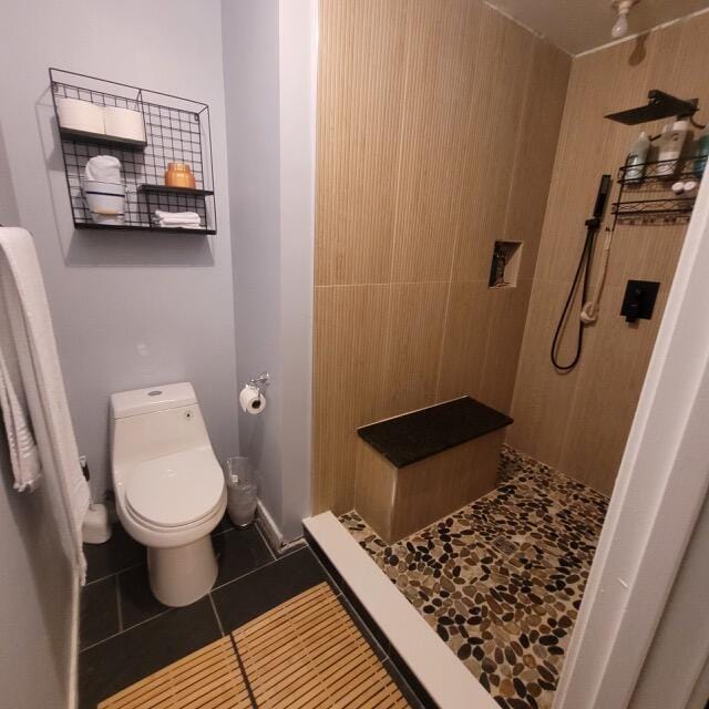 7886 Racquet Rd, North Charleston, SC 29418 - bathroom featuring a shower stall, tile patterned flooring, and toilet