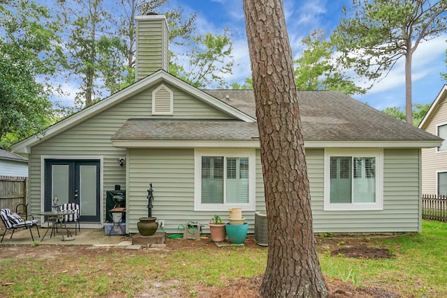 7886 Racquet Rd, North Charleston, SC 29418 - back of house with a shingled roof, a chimney, and a patio
