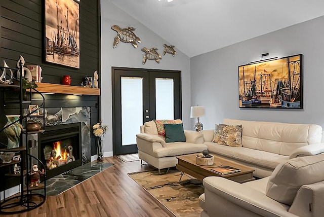 7886 Racquet Rd, North Charleston, SC 29418 - living room with wood finished floors, lofted ceiling, french doors, and a high end fireplace