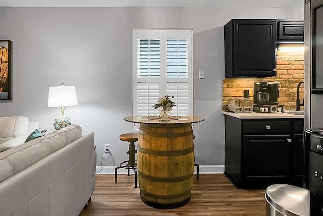 7886 Racquet Rd, North Charleston, SC 29418 - bar area with wood finished floors, baseboards, and a sink