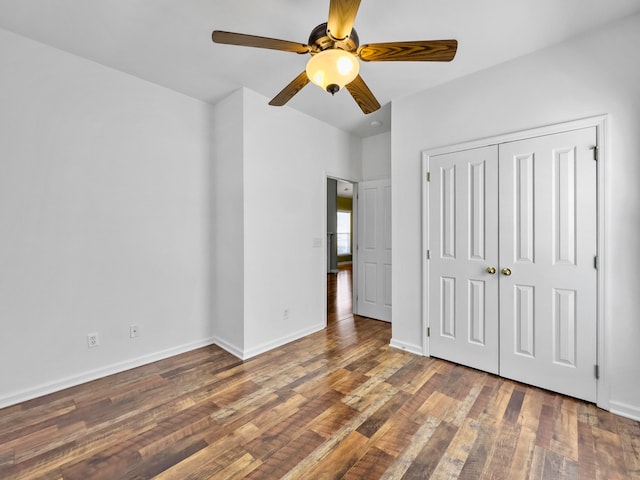 unfurnished bedroom featuring ceiling fan, hardwood / wood-style flooring, and a closet