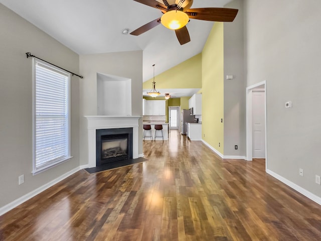 unfurnished living room with high vaulted ceiling, ceiling fan, and hardwood / wood-style flooring