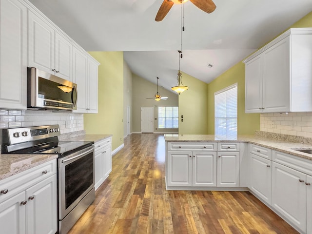 kitchen with tasteful backsplash, wood-type flooring, ceiling fan, and stainless steel appliances