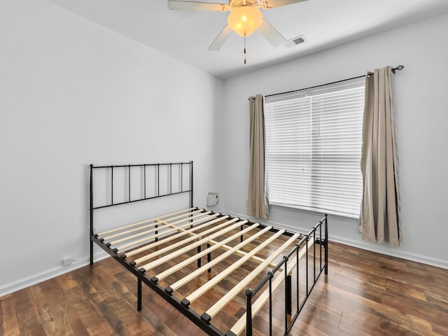 bedroom featuring dark hardwood / wood-style floors and ceiling fan