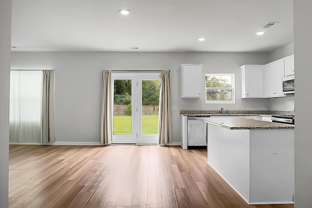 717 Butter Rd, Bonneau, SC 29431 - kitchen featuring stainless steel appliances, light wood-style floors, white cabinets, dark stone countertops, and recessed lighting