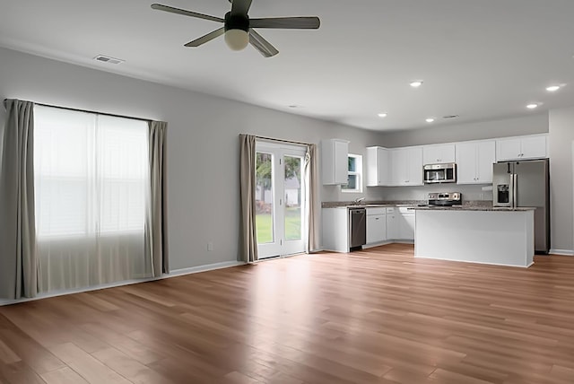 717 Butter Rd, Bonneau, SC 29431 - kitchen featuring appliances with stainless steel finishes, recessed lighting, light wood-style flooring, open floor plan, and white cabinets