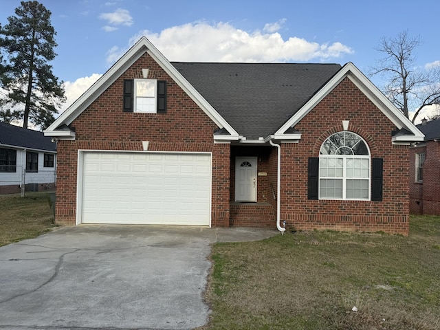 view of front of home with a garage and a front lawn