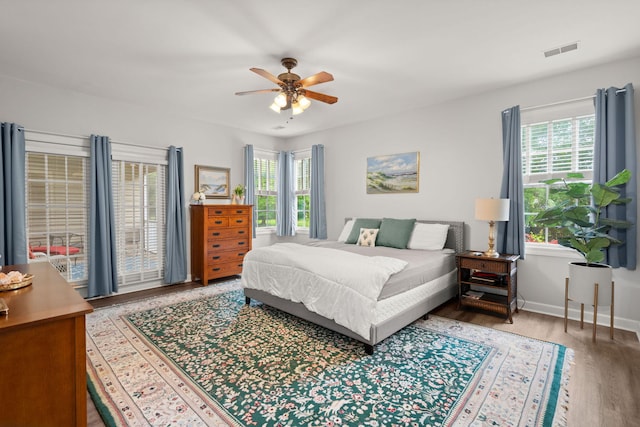 2772 Latrobe Ct, Mount Pleasant, SC 29466 - bedroom featuring multiple windows, wood finished floors, baseboards, and a ceiling fan