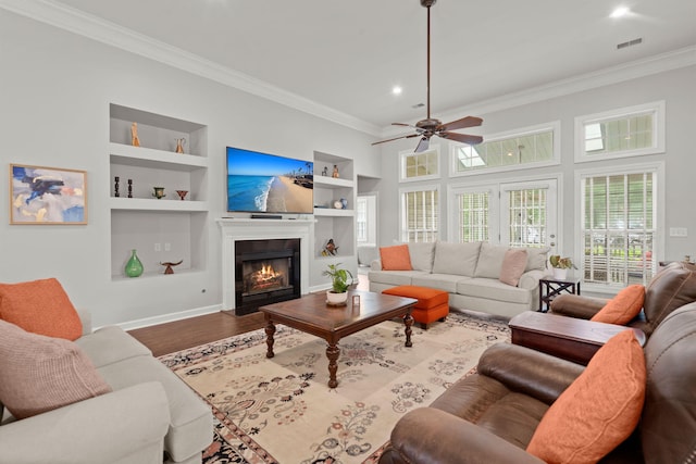 2772 Latrobe Ct, Mount Pleasant, SC 29466 - living area with built in shelves, ornamental molding, a ceiling fan, baseboards, and a fireplace with flush hearth