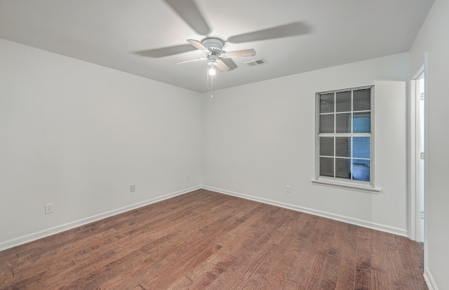 empty room with ceiling fan and dark wood-type flooring