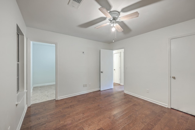 unfurnished bedroom featuring ceiling fan and dark hardwood / wood-style floors