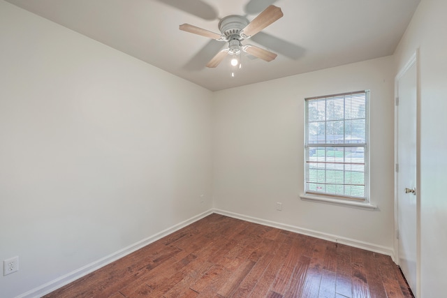 spare room with ceiling fan and dark wood-type flooring