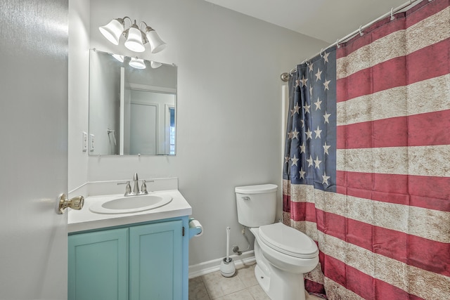 bathroom featuring toilet, vanity, tile patterned floors, and walk in shower