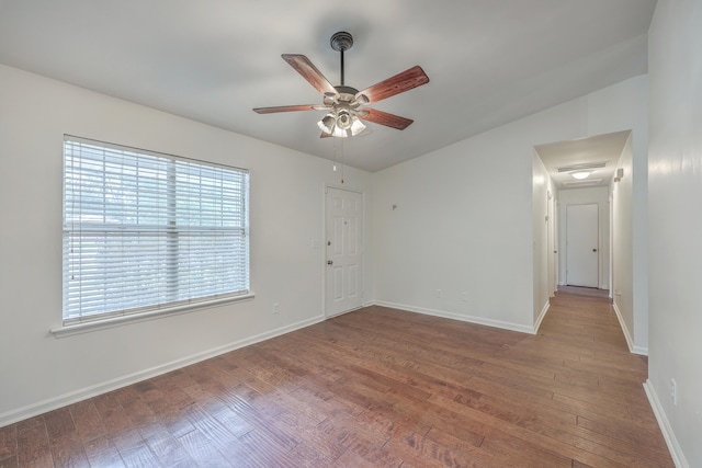 unfurnished room with wood-type flooring, ceiling fan, and lofted ceiling