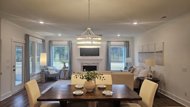 dining room featuring dark wood-type flooring, visible vents, and a wealth of natural light