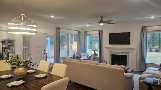 living area with a high end fireplace, recessed lighting, ceiling fan, and dark wood-style flooring