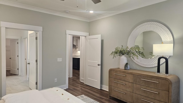 bedroom with crown molding, wood finished floors, baseboards, and ceiling fan