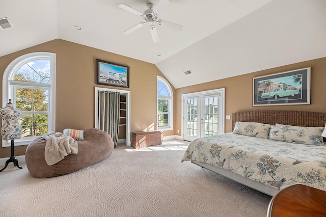 bedroom with vaulted ceiling, french doors, multiple windows, and access to exterior