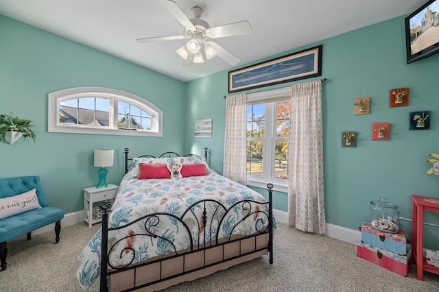 bedroom with light carpet, ceiling fan, and baseboards