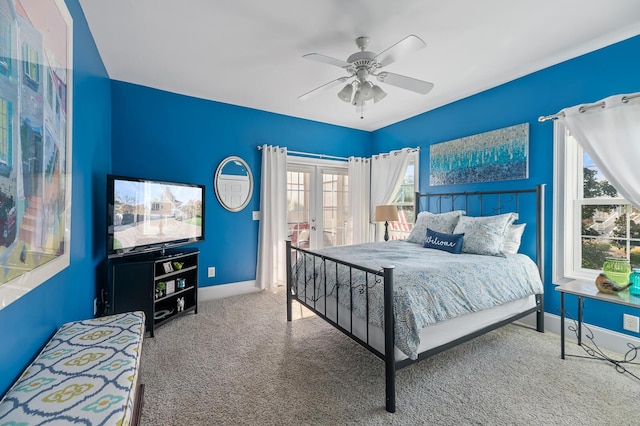 carpeted bedroom with french doors, ceiling fan, and baseboards