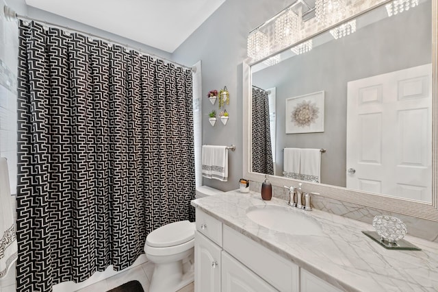 bathroom with toilet, tile patterned flooring, and vanity