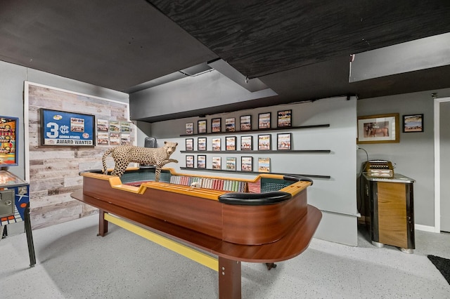 recreation room featuring speckled floor