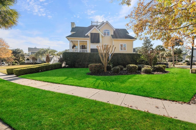 view of front of home featuring a chimney and a front yard