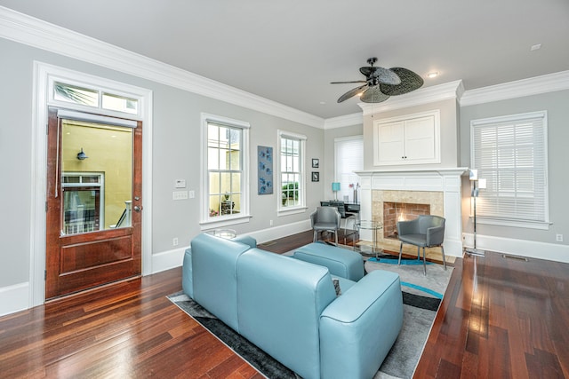 living room featuring ornamental molding, a premium fireplace, dark wood finished floors, and baseboards