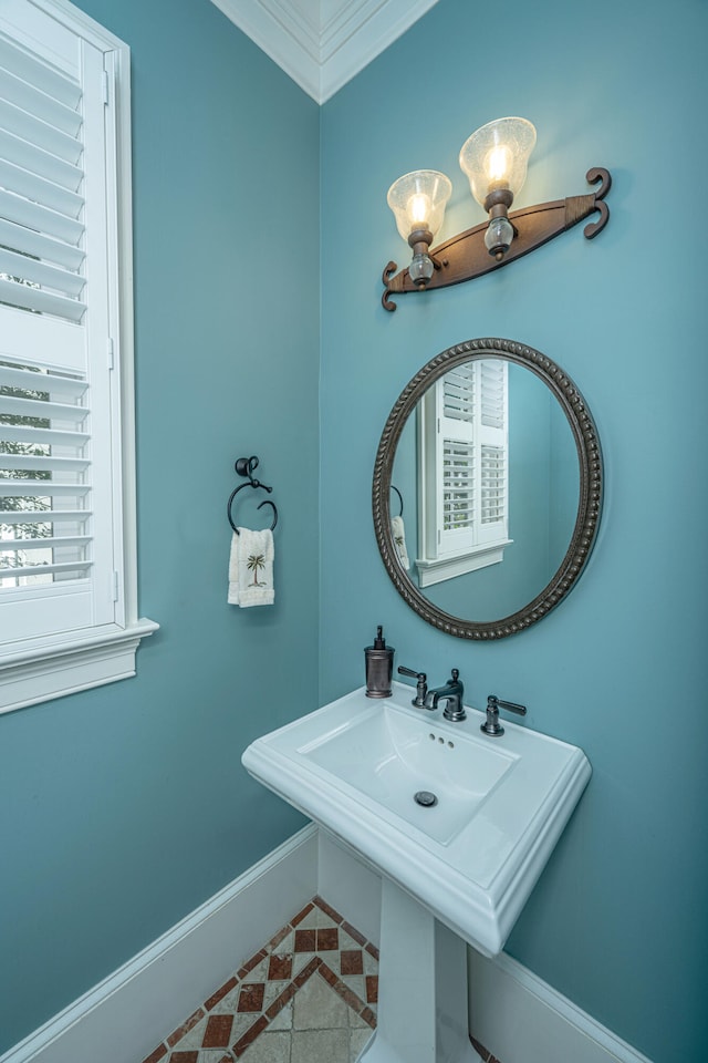 bathroom with baseboards and tile patterned floors