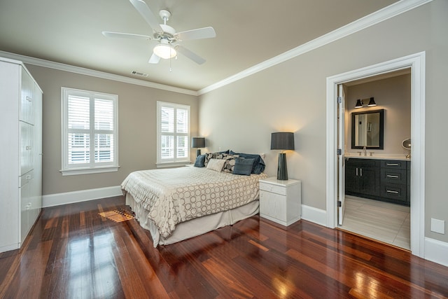 bedroom featuring ornamental molding, wood finished floors, visible vents, and baseboards