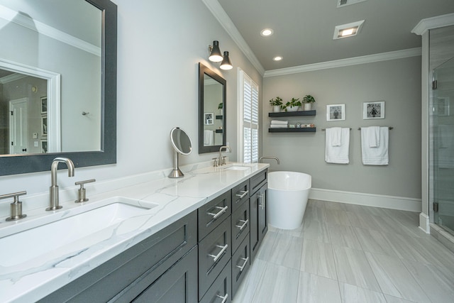 bathroom with ornamental molding, a freestanding tub, a sink, and baseboards