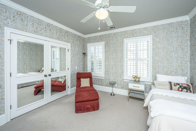 bedroom featuring wallpapered walls, visible vents, baseboards, ornamental molding, and carpet floors