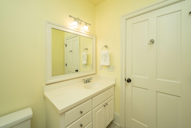 half bath with vanity and toilet