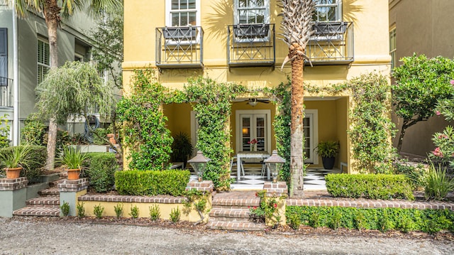 exterior space with french doors and stucco siding