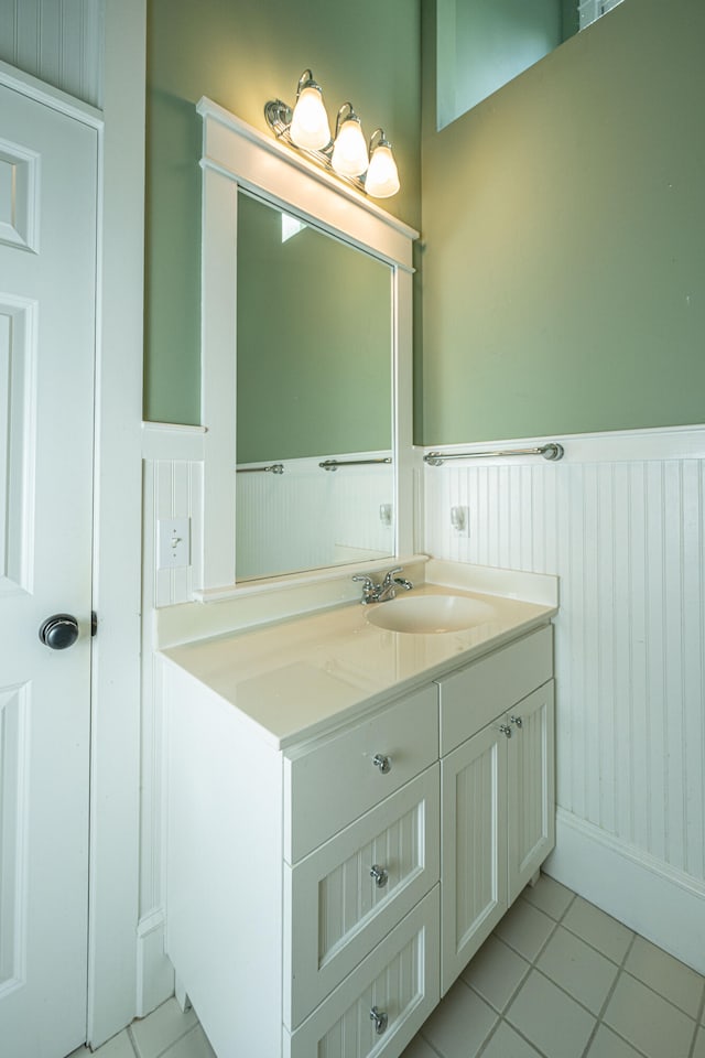 bathroom featuring a wainscoted wall, vanity, and tile patterned floors