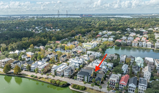 drone / aerial view featuring a water view and a residential view