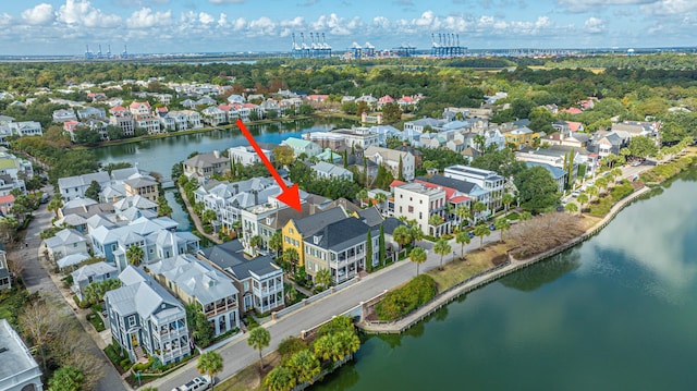 drone / aerial view featuring a water view and a residential view