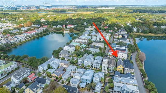 drone / aerial view featuring a water view and a residential view