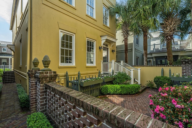 exterior space featuring fence and stucco siding