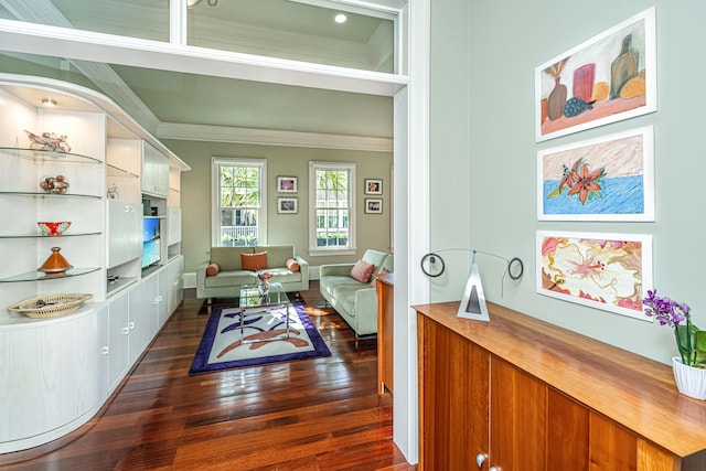 sitting room with dark wood finished floors and crown molding