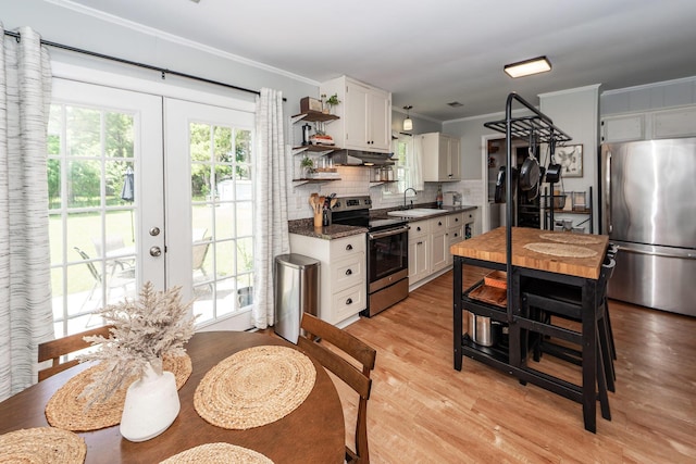 kitchen featuring french doors, a sink, white cabinetry, and stainless steel appliances
