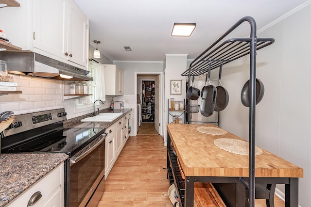 kitchen featuring white cabinetry, stainless steel electric stove, a sink, and light wood-style flooring