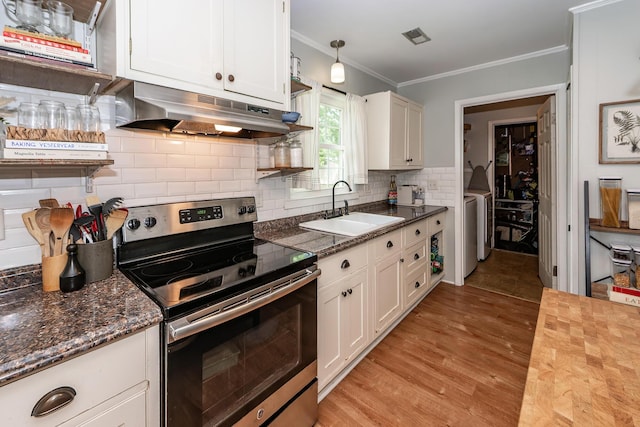 kitchen featuring a sink, stainless steel range with electric stovetop, white cabinetry, tasteful backsplash, and under cabinet range hood