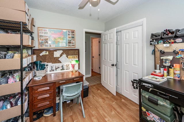 office space with light wood-style floors and a ceiling fan
