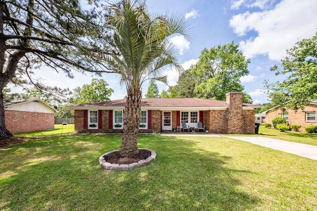 ranch-style house featuring brick siding, a front lawn, driveway, and a chimney