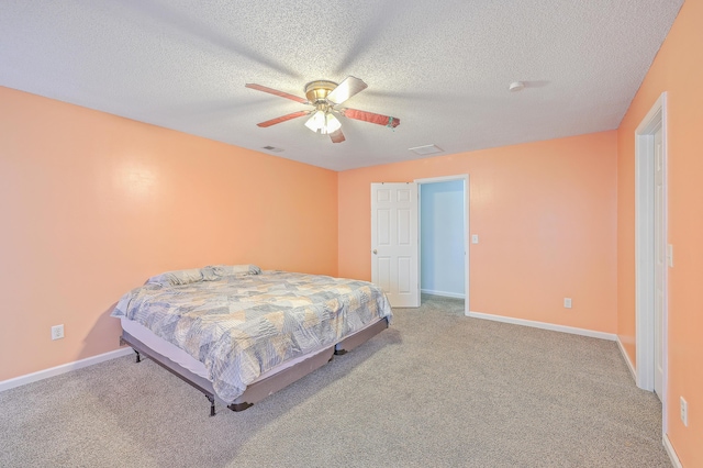 bedroom featuring carpet flooring, a textured ceiling, and ceiling fan