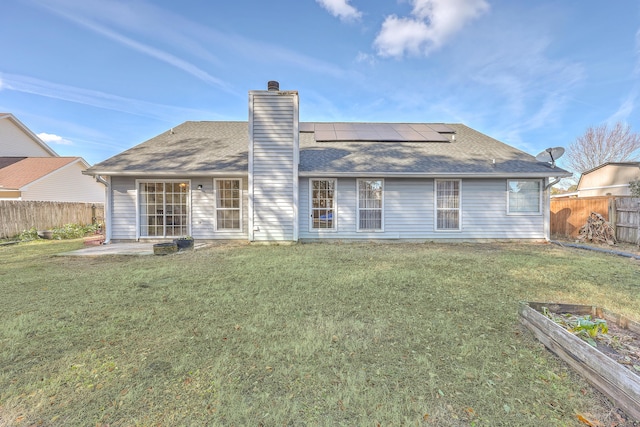 rear view of house featuring a patio area and a lawn