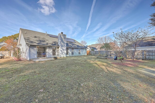 back of house featuring a yard